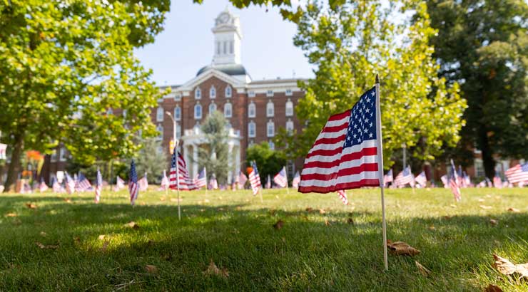 Flags adorn Alumni Plaza in front of Kutztown University's Old Main in honor of Remembrance Day.