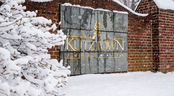Kutztown University sign in winter snow.
