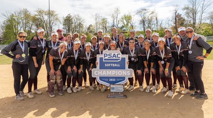 softball team poses with PSAC championship trophy