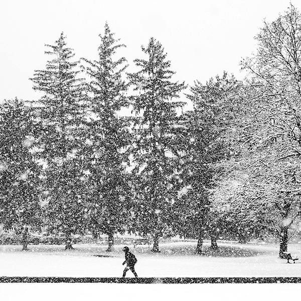 student walking through snow storm