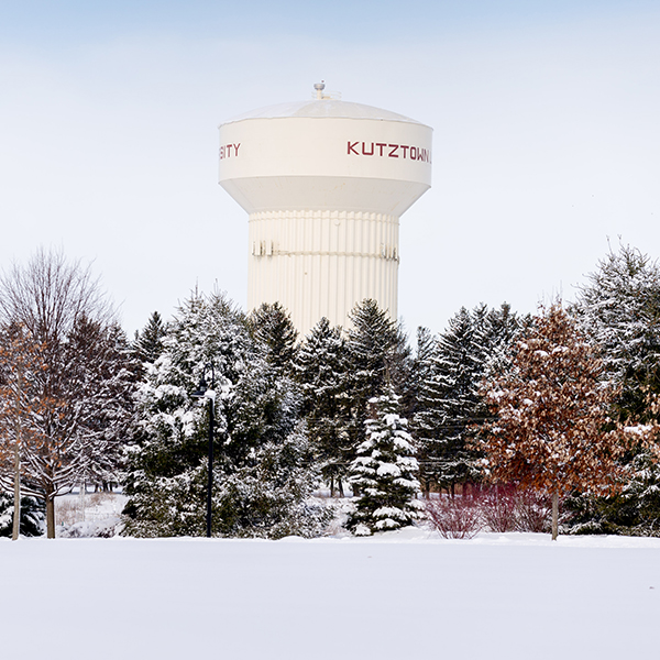 kutztown water tower peeking through snow covered trees