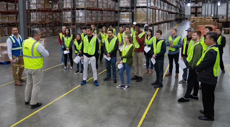 KU students who are pursuing a supply chain degree get a tour of a local supply chain facility.