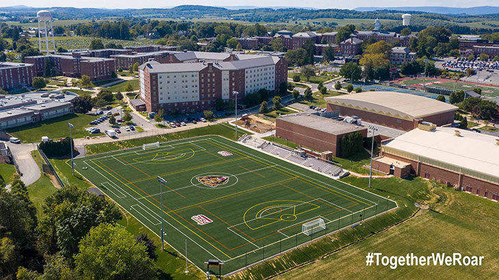 And arial view of the south side of campus from the field behind keystone hall through the back of Old Main.