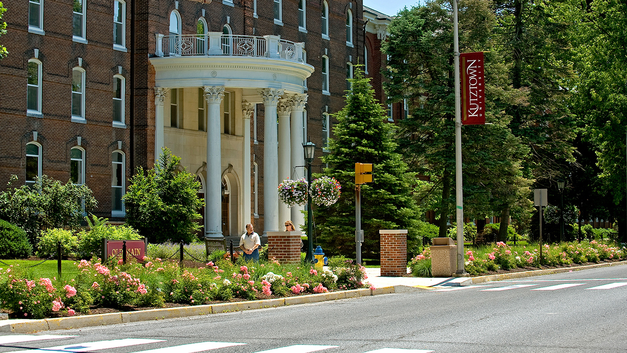 Front quarter view of Old Main and Main Street on a sunny day